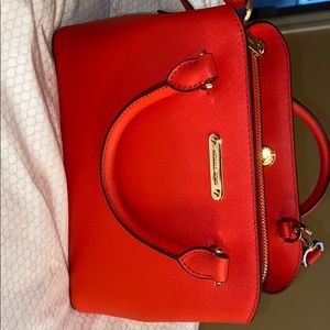 Red/coral Michael kors purse with gold details